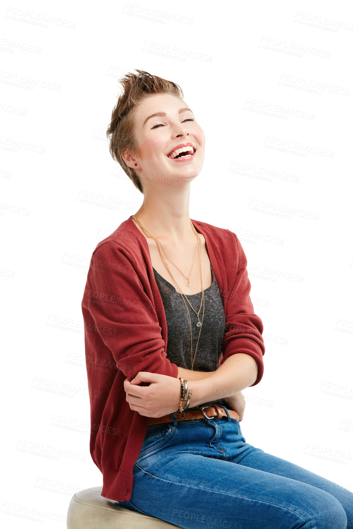 Buy stock photo Studio portrait of a joyful young woman sitting on a chair against a white background