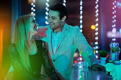 Buy stock photo Shot of two young people chatting at a bar
