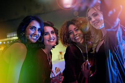 Buy stock photo Shot of a group of friends taking a selfie at a nightclub