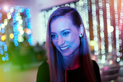 Buy stock photo Shot of a young woman dancing on her own at a nightclub