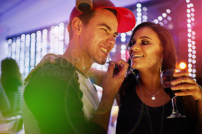 Buy stock photo Shot of a young couple enjoying themselves at a nightclub