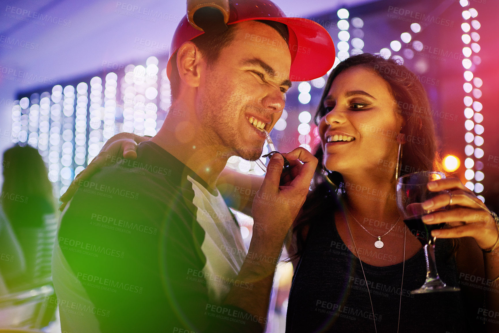 Buy stock photo Shot of a young couple enjoying themselves at a nightclub