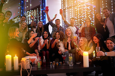 Buy stock photo Shot of a large group of young people enjoying themselves at a nightclub