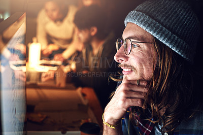 Buy stock photo Cropped shot of a designer working on his computer on a night shift at work