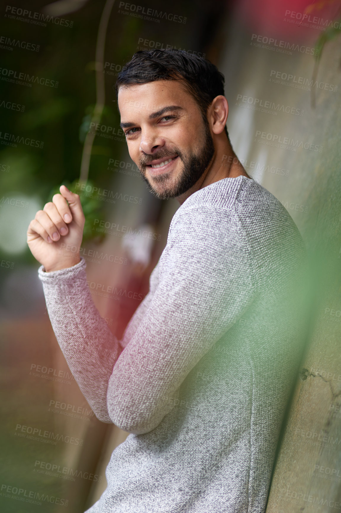 Buy stock photo Portugal man, smile and casual fashion in portrait on wall, outdoors and relaxing in city. Male person, confident and happy in urban town for travel, pride and informal wear for comfort on concrete