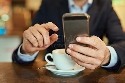 Buy stock photo Shot of an unrecognizable businessman sending a text message while sitting in a coffee shop