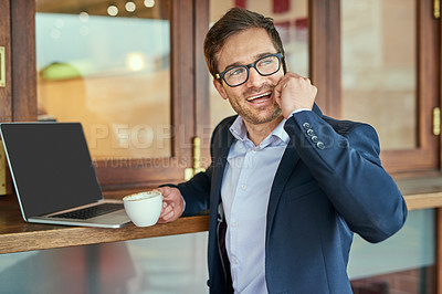 Buy stock photo Shot of a young businessman making a phonecall while sitting in a coffee shop