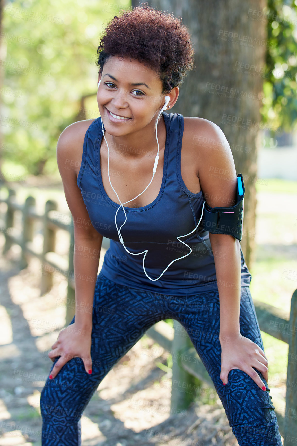 Buy stock photo Portrait, woman and fitness with woods, outdoor and exercise for workout, training and wellness. Female athlete, armband and nature in sports, physical activity and smile in forest with earphones