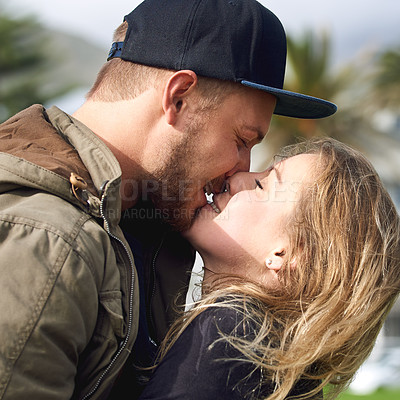 Buy stock photo Shot of an affectionate young couple spending time together outdoors