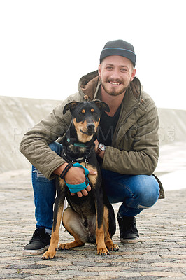 Buy stock photo Portrait of a young man and his dog spending time together outdoors
