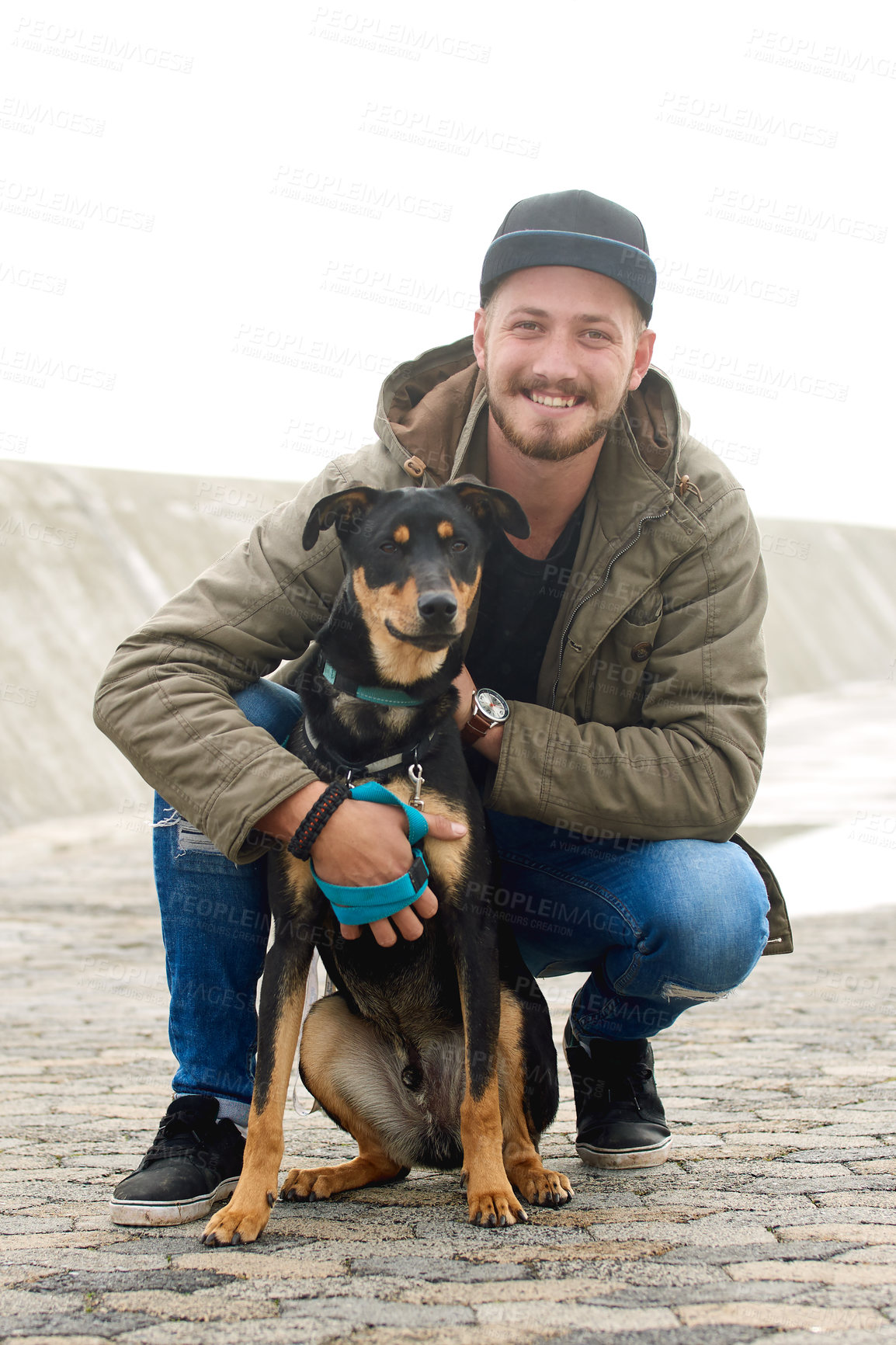 Buy stock photo Portrait of a young man and his dog spending time together outdoors