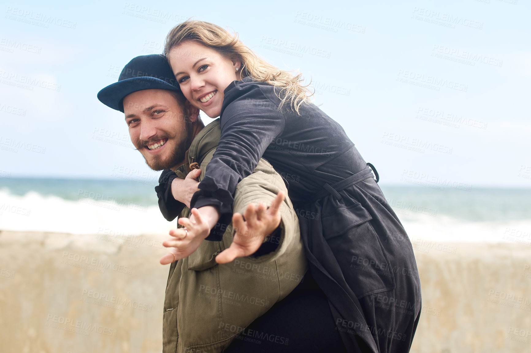 Buy stock photo Portrait of an affectionate young couple spending time together outdoors