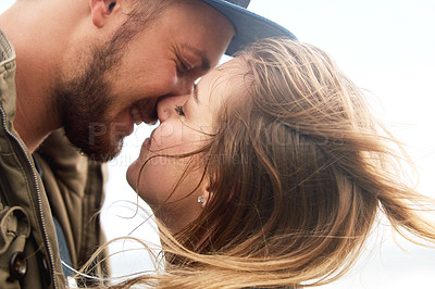 Buy stock photo Couple, romance and close together in nature for kiss, hug and happiness with each other. Smiling man, woman and love on beach for wellness, relationship and bonding for marriage or anniversary