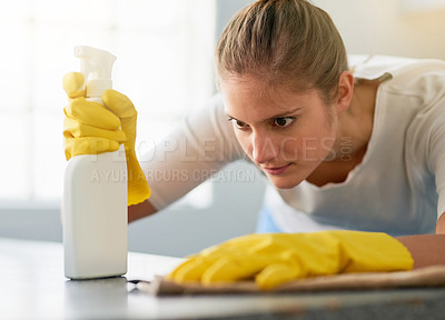 Buy stock photo Woman, kitchen spray and cleaning table in home for hygiene, housework or housekeeping service for safety. Chores, bottle and maid with cloth on counter to wipe dirt, dust and bacteria in apartment