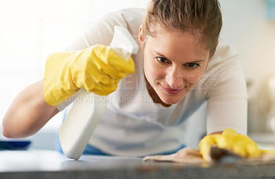 Buy stock photo Woman, kitchen counter and cleaning spray in home for hygiene, housework or housekeeping service for safety. Chores, bottle and maid with cloth on table to wipe dirt, dust and bacteria in apartment