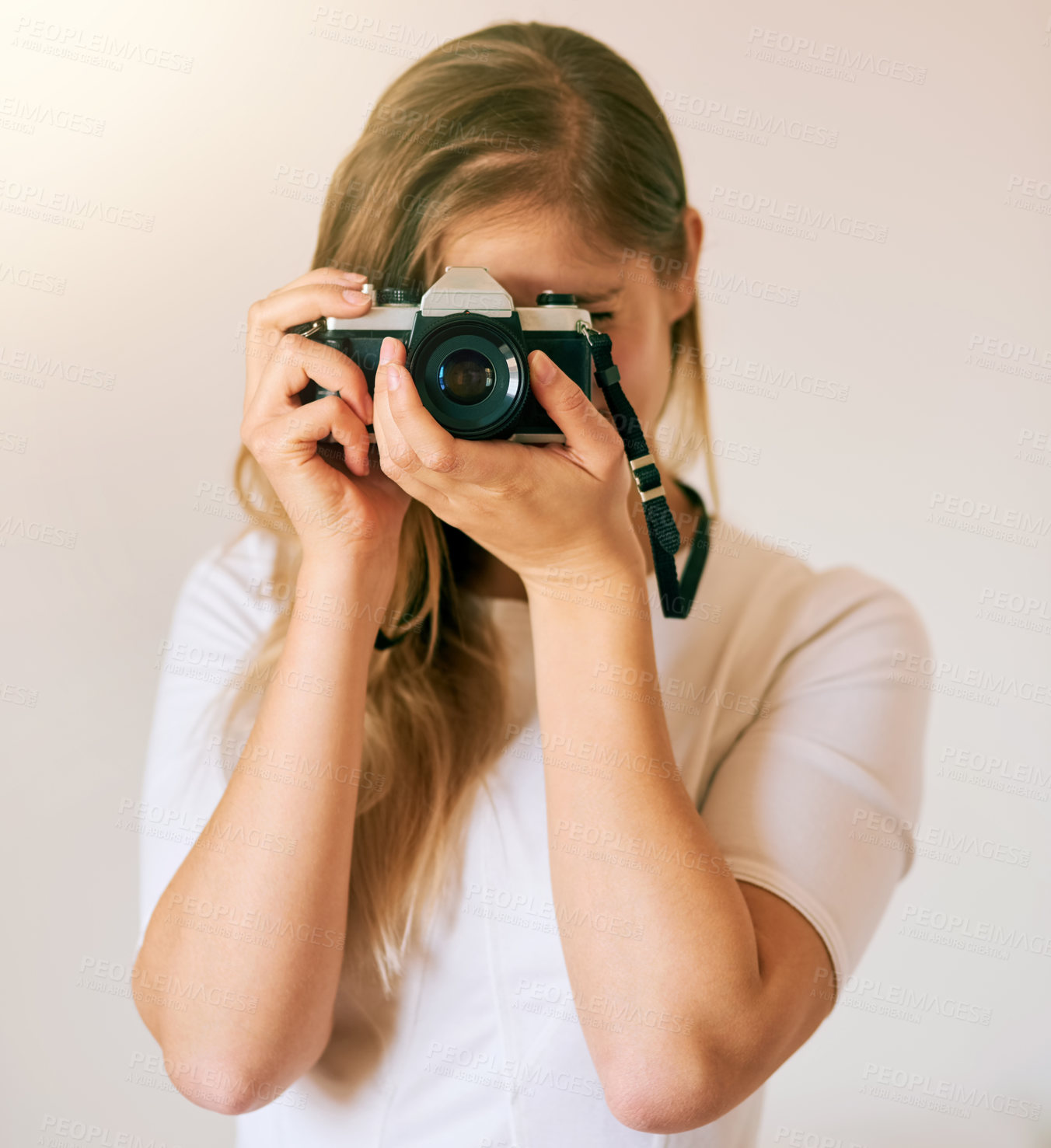 Buy stock photo Shot of an unrecognizable young woman taking a photo with her camera at home