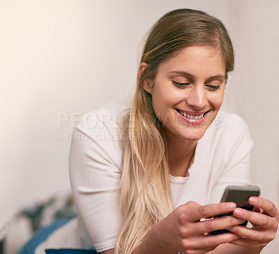 Buy stock photo Home, woman and happy on smartphone for social media, networking and communication. Female person, smile and online or internet dating with mobile app, website and satisfied with text or message