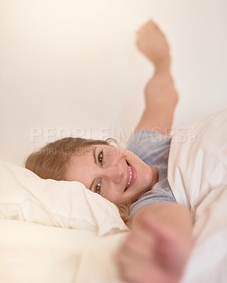 Buy stock photo Portrait of a young woman stretching in bed after waking up