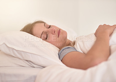 Buy stock photo Cropped shot of a young woman sleeping peacefully in her bed