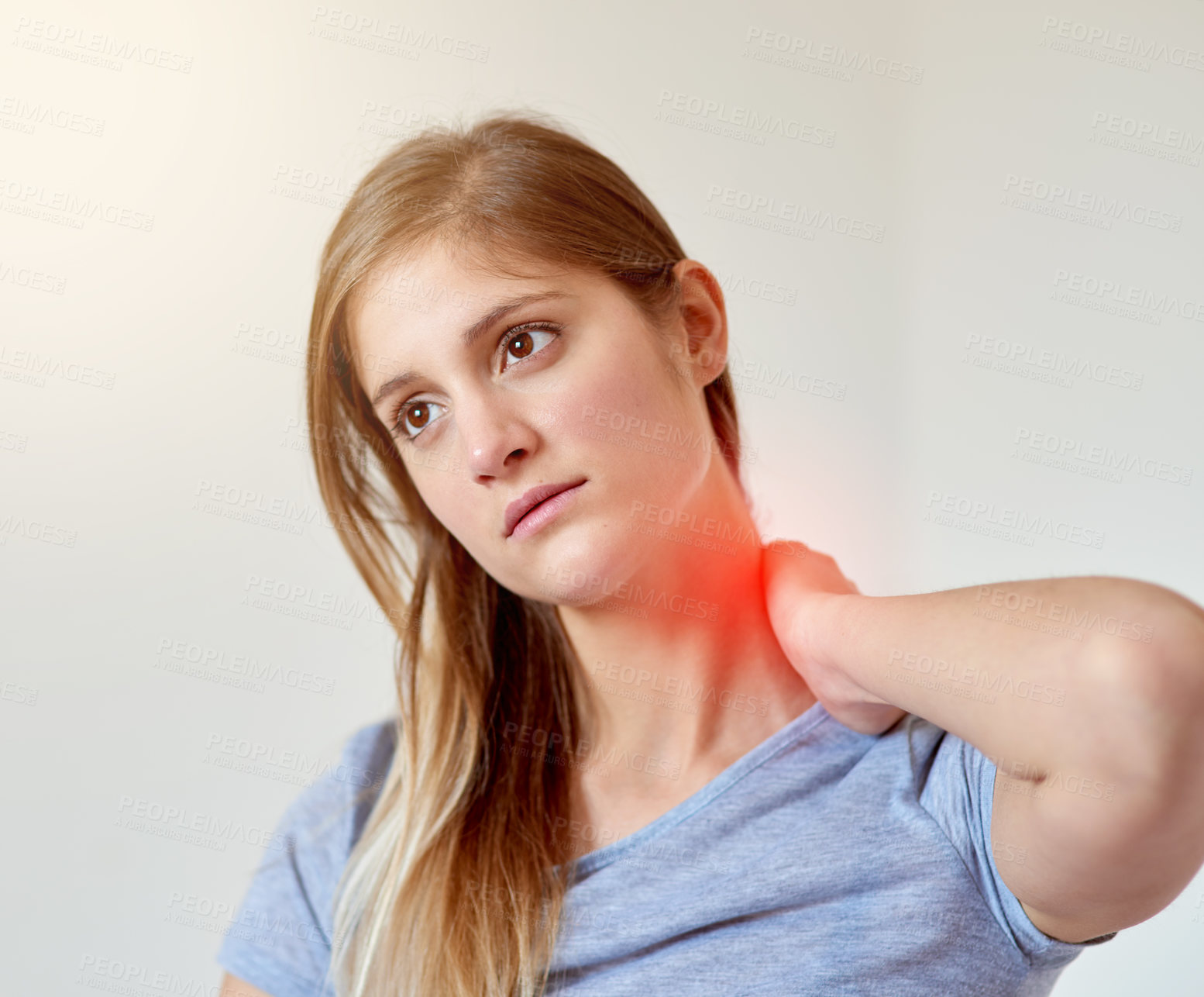 Buy stock photo Cropped shot of a young woman experiencing neck pain highlighted in glowing red