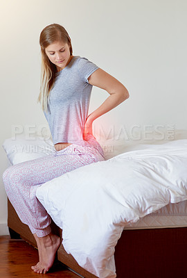 Buy stock photo Shot of a young woman experiencing back pain highlighted in glowing red