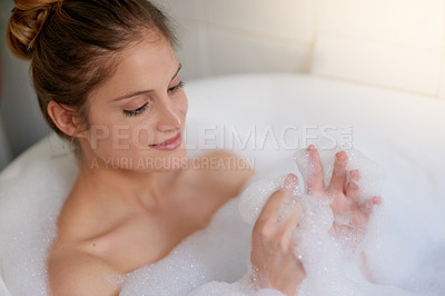 Buy stock photo Cropped shot of a beautiful young woman relaxing in the bathtub