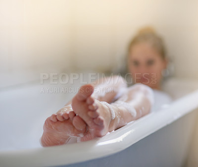 Buy stock photo Shot of a beautiful young woman relaxing in the bathtub