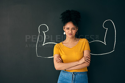 Buy stock photo Shot of a woman posing with a chalk illustration of flexing muscles against a dark background