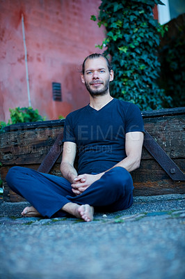 Buy stock photo Portrait of a man sitting against a wall outside