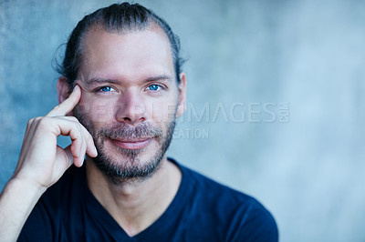 Buy stock photo Shot of a young man Portrait of a man sitting against a wall outside