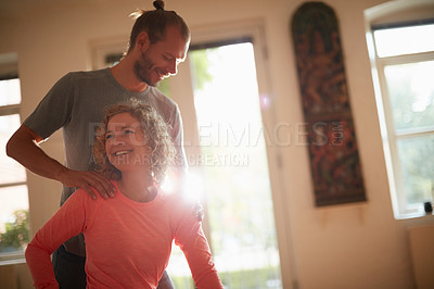 Buy stock photo Shot of a yoga instructor guiding one of his students
