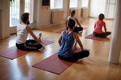 Buy stock photo Rearview shot of a group of people attending a yoga class