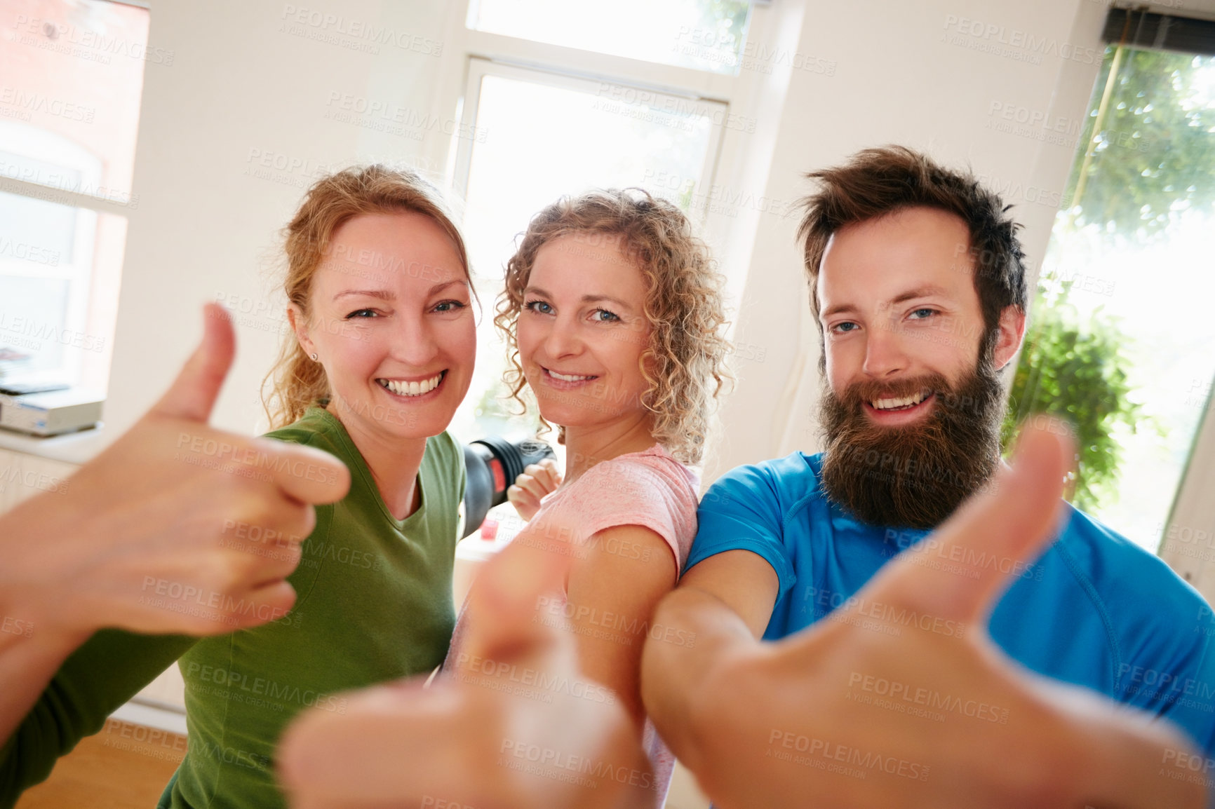 Buy stock photo Shot of a group of yoga enthusiasts standing together in a studio