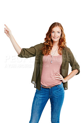 Buy stock photo Shot of a young woman pointing against a white background