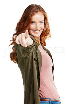 Buy stock photo Studio shot of a young woman pointing against a white background