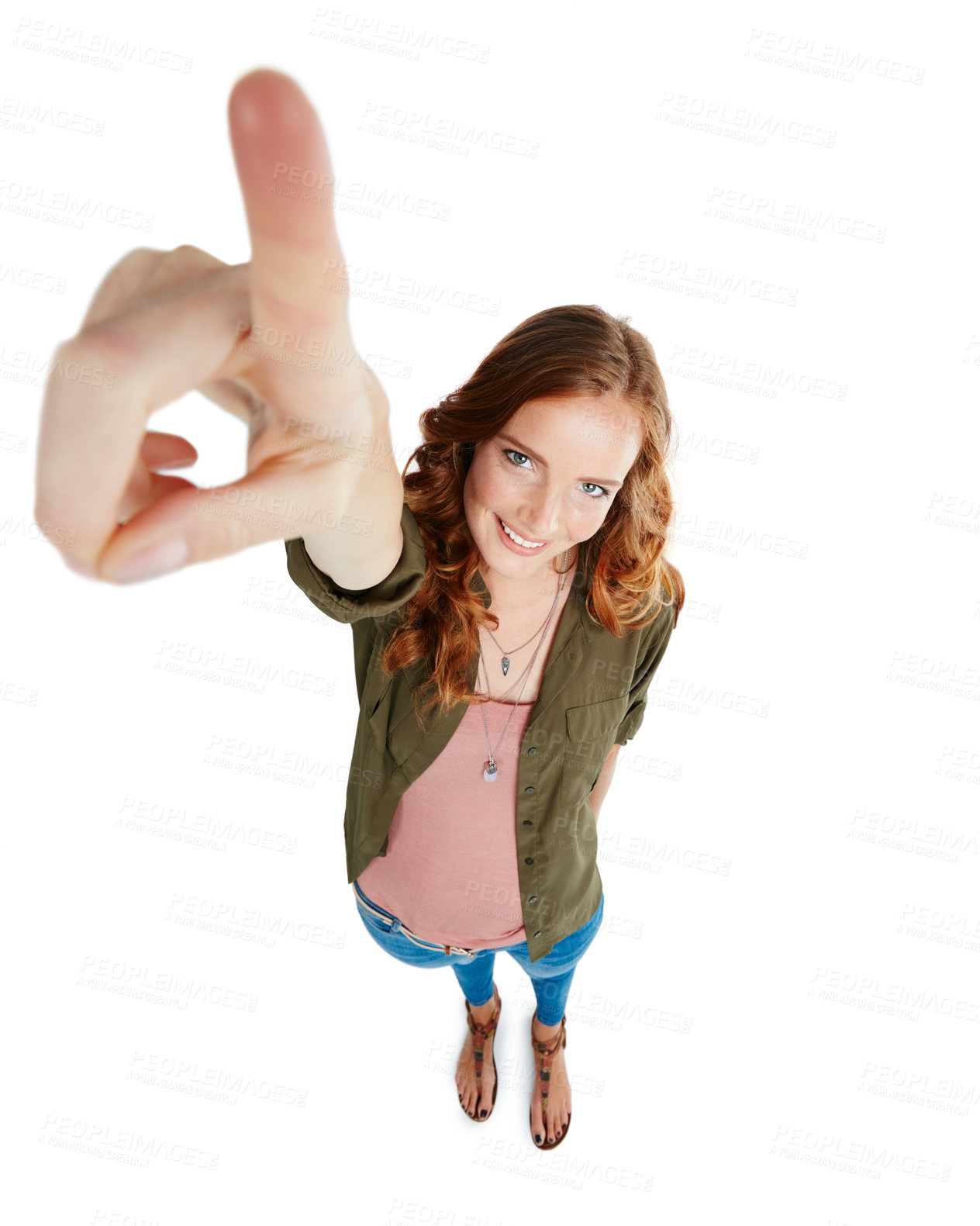 Buy stock photo Shot of a young woman pointing against a white background