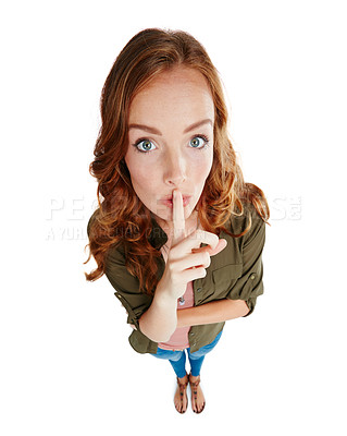 Buy stock photo Studio shot of a young woman posing with her finger on her lips
