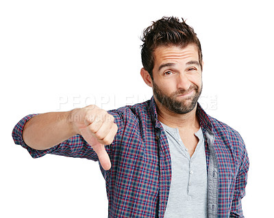 Buy stock photo Studio shot of a young man showing thumbs down against a white background