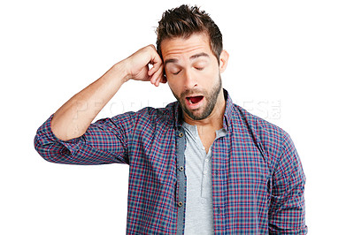 Buy stock photo Studio shot of a young man yawning against a white background