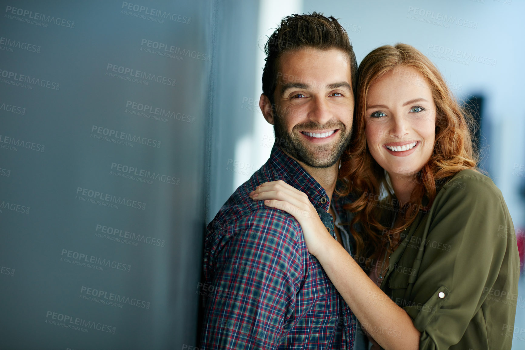 Buy stock photo Portrait of a happy young couple leaning against a blackboard