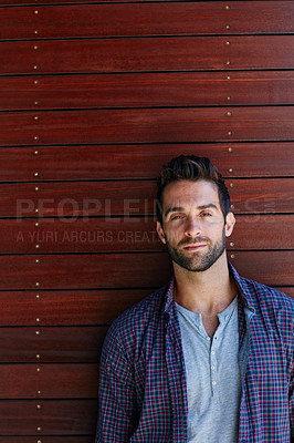 Buy stock photo Portrait of a handsome man standing against a wooden wall
