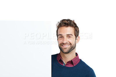 Buy stock photo Portrait, studio and man with a board with mockup space for marketing, advertising or product placement. Happy, smile and male model with a banner, poster or signage isolated by a white background.