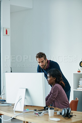 Buy stock photo Cropped shot of colleagues working together on a computer in an office