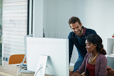 Buy stock photo Cropped shot of colleagues working together on a computer in an office