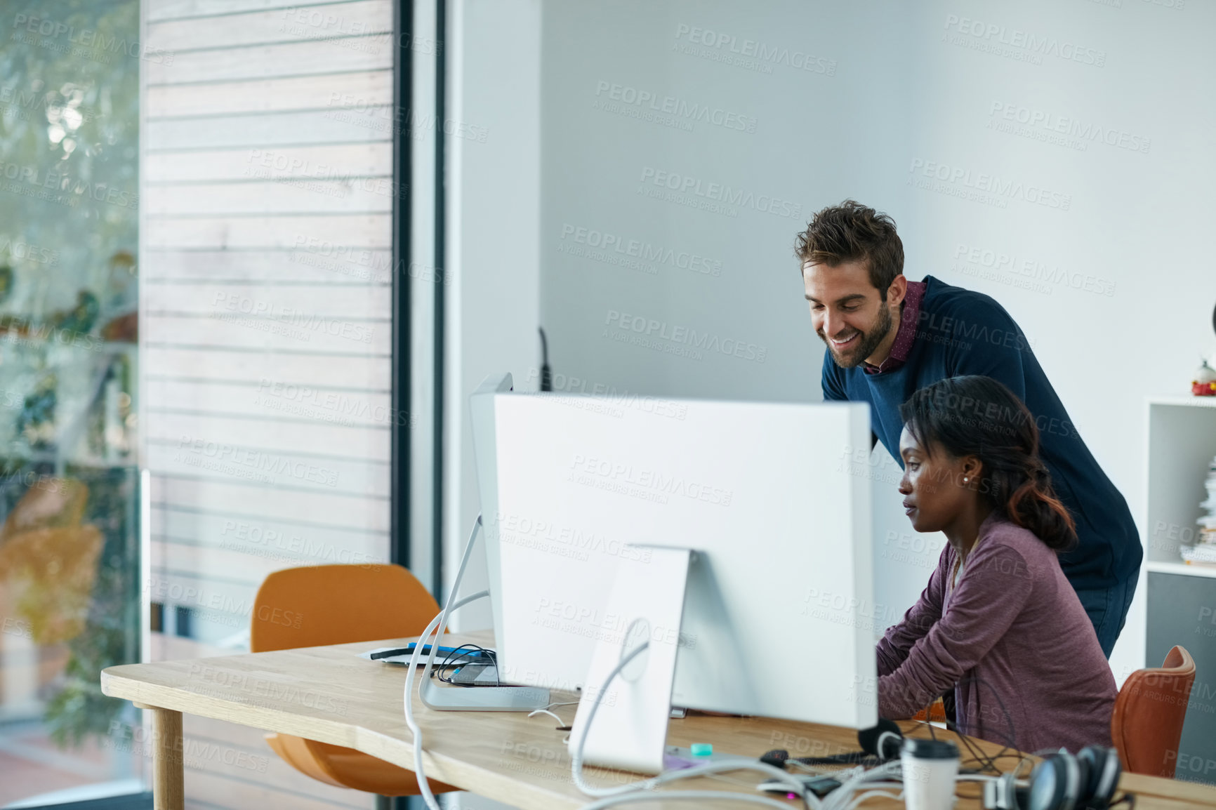 Buy stock photo Cropped shot of colleagues working together on a computer in an office