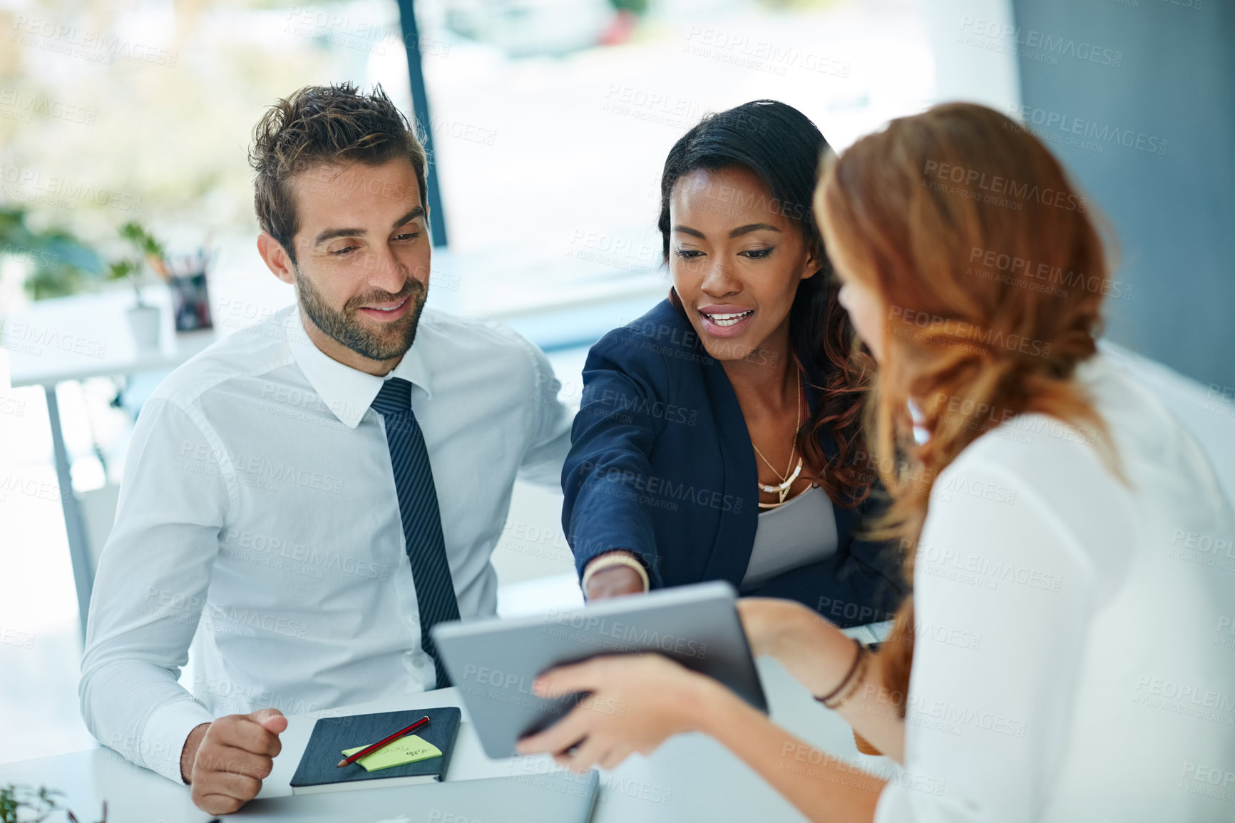 Buy stock photo Cropped shot of a young couple meeting with their advisor in an office
