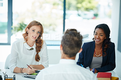 Buy stock photo Cropped shot of a man being interviewed by two businesswomen in an office