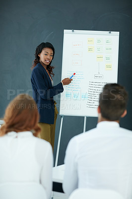 Buy stock photo Cropped shot of a young businesswoman giving a presentation to her colleagues in an office