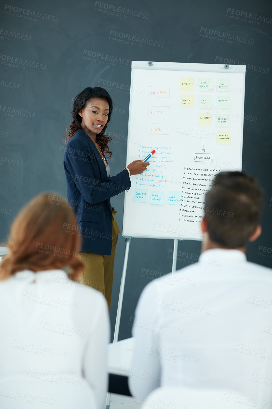 Buy stock photo Cropped shot of a young businesswoman giving a presentation to her colleagues in an office