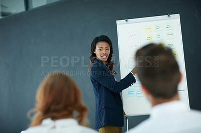 Buy stock photo Cropped shot of a young businesswoman giving a presentation to her colleagues in an office